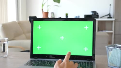 Close Up of Man Working on the Computer with a Green Screen