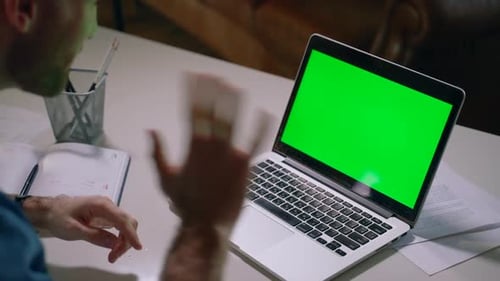 Man Gesturing at Laptop Green Screen