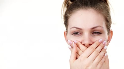 Woman Covering Mouth with Hands, Close Up