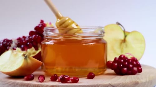 Honey Drips from Wooden Honey Dipper in Close-Up