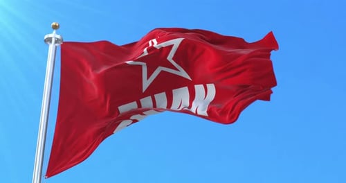 Red Flag with Star Waving Against Blue Sky