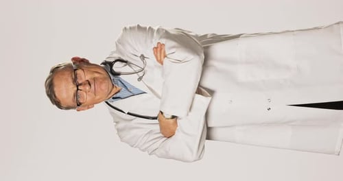 Senior Doctor with Stethoscope Crosses Arms