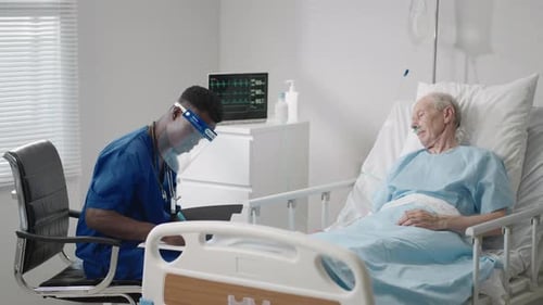 Healthcare Worker Checking Up On Elderly Patient