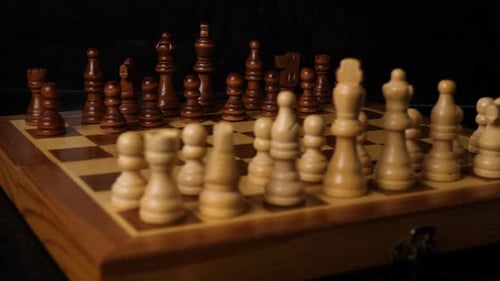Macro shot behind chess figures on a chess board.