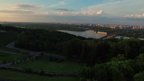Aerial View Green Park on River Shore in Summer City. City Panorama From Drone