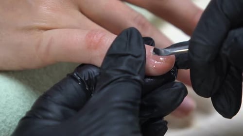 Master Removing Cuticle From Female Client Nails, Beauty Salon Service