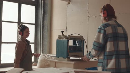Two Carpenters Working in Workshop