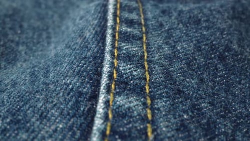 Close Up of Denim Seam with Yellow Stitching