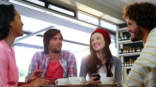 Friends interacting while having coffee