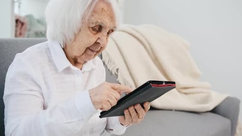 Senior Woman Using Tablet at Home