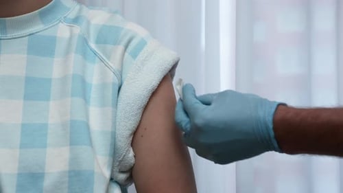 Medical Professional Giving a Patient a Shot