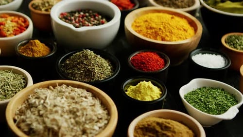 Variety of Colorful Spices and Herbs in Bowls