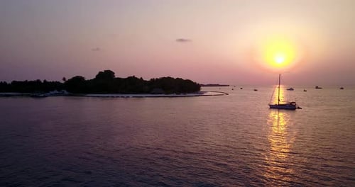 Wide birds eye tourism shot of a white sand paradise beach and turquoise sea background in high reso