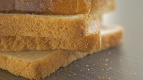 Bread pieces arranged on table top close-up tilting 4K 2160p UltraHD footage - Toast bread on table