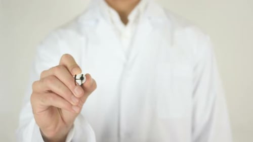 Doctor Writing Health Care Message on Clear Surface