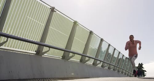 Sporty Caucasian woman exercising outdoor on a bridge