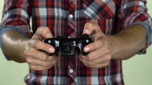 Person Playing Video Game with Controller Close Up