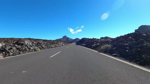 Long asphalt road ground view with sunset light and travel concept - mountain and sky