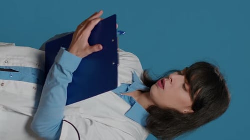 Medical Professional Reviewing Clipboard in Portrait Video