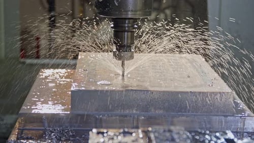 CNC mill manufacturing an advanced metal part with liquid cooling