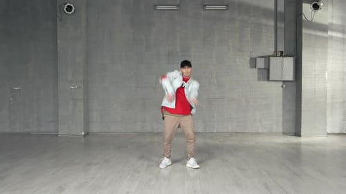 Energetic Man Dancing in a Bright Studio