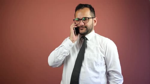 Bearded Businessman Using Mobile Phone in Office