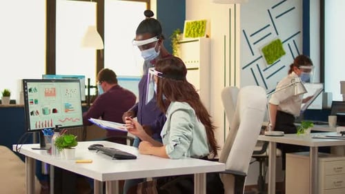 Colleagues Reviewing Data at Computer in Bright Office