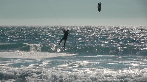 Man Kite Surfing on Wavy Ocean Waters
