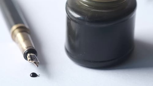 Close Up of Fountain Pen and Ink on a Paper