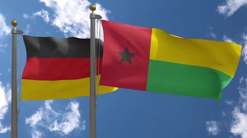 Flags of Germany and Guinea-Bissau Waving in Sky
