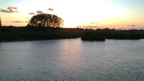 Golden Sunset Over Calm Lake, Aerial View