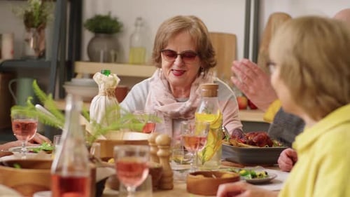 Seniors Gather Around Table for Meal and Conversation