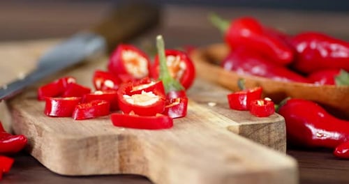 Fresh Red Chili Peppers Sliced on Cutting Board