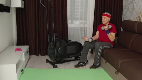 Senior Man Lifts Weights in Home Exercise Setting