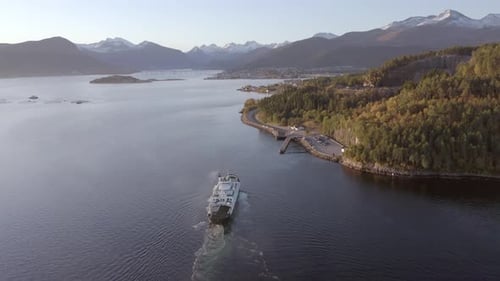Norwegian Ferry Service Crossing a Fjord Carrying Passengers and Vehicles
