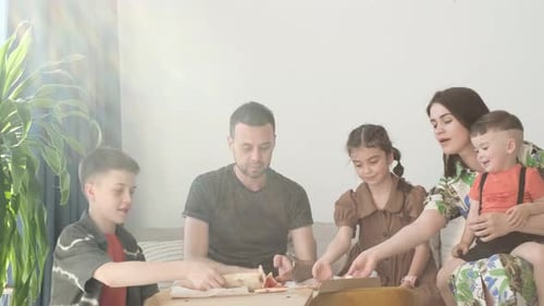 Happy Family Enjoys Pizza Together at Home