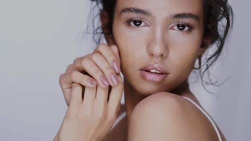 Beautiful Woman Posing Against a White Background