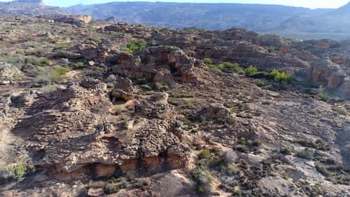 Male rock climber walking over a rocky mountain 4k
