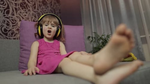 Young Child Enjoying Music With Headphones at Home