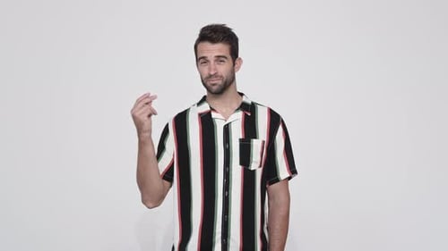 Man Smiles and Gestures in Studio