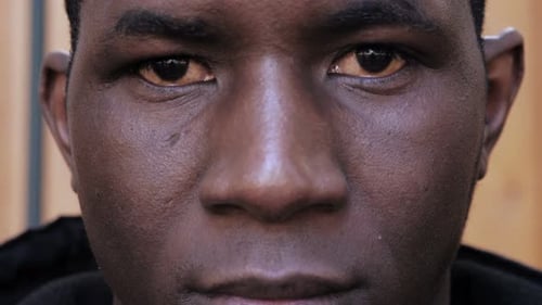 Black african migrant staring at camera.Migration,seeker