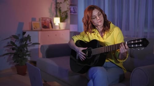 Young Woman Playing Guitar and Singing