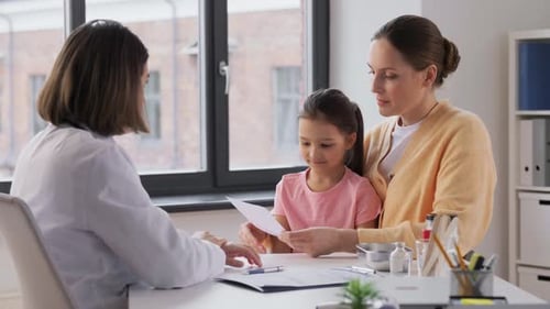Mother with Little Daughter and Doctor at Clinic