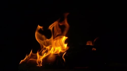 Toy Car Engulfed in Flames on Black Background