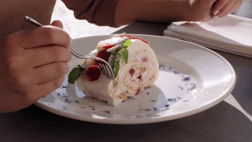 Eating Delicious Strawberry Roll Cake with Fork