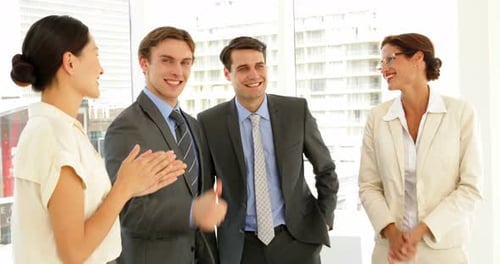 Business Team Celebrates Success in Bright Office