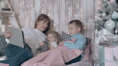 Mother and Children Watching Tablet at Christmas Time