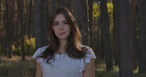 Young Woman Posing in a Green Forest