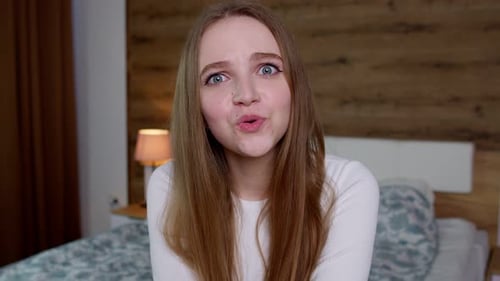 Surprised Young Woman Reacting in Bedroom