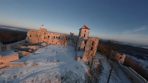Aerial View of Beautiful Historic Castle Ruins on the Hill in Winter at Sunset